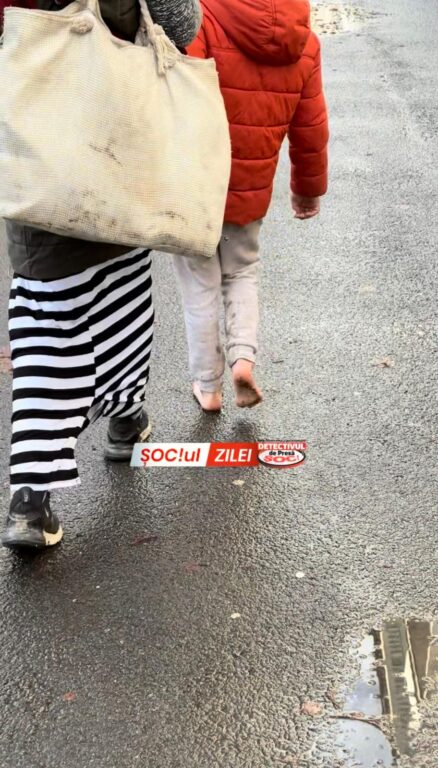 1000174033-438x768 SĂLTAT de poliție după ce l-a ÎMBRÂNCIT și împiedicat pe Detectivul să filmeze cum o copilă, desculță, era obligată de mama sa să cerșească!